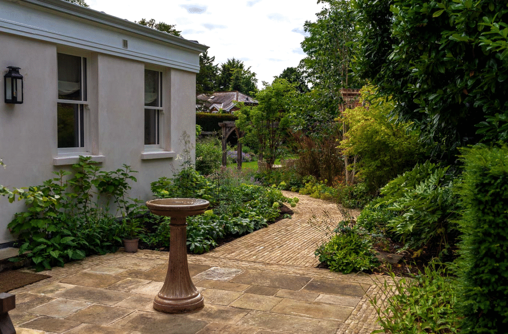 Existing bird bath set within new landscaping brings wildlife to the side garden